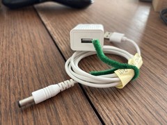 white AC-to-DC wall power adapter and USB-barrel connector cable.